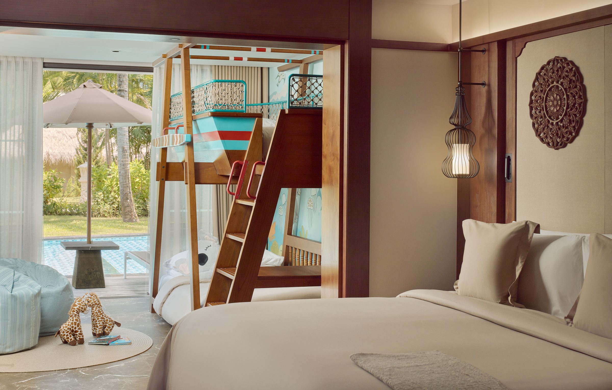 A Family Concierge Junior Suite Lagoon Access at Paradisus by Meliá Bali, with a boat-shaped bunk bed for children and steps out to the lagoon pool